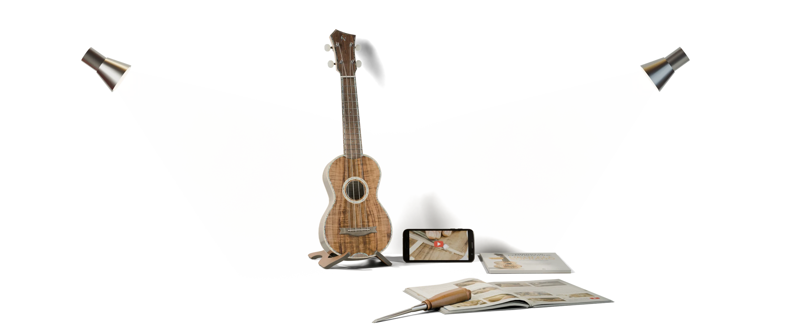 Ukulele artigianale, libro e scalpello su un telo da lavoro
